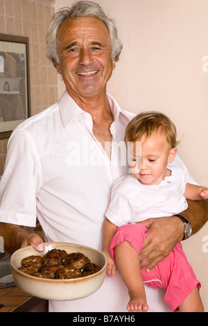 Portrait of Grandpa Holding Bowl of Food Stock Photo