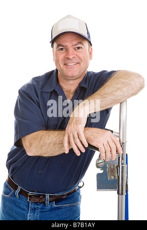 Friendly delivery man or mover leaning on his hand truck Stock Photo