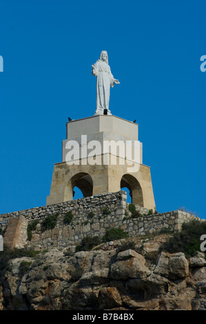 Religious Statue of Jesus Christ at the end of The Jairan Wall Of La Conjunto Monumental De La Alcazaba Almeria Spain Stock Photo