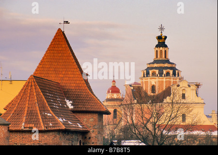 St Casimir Church on right and barbican at town walls on left in Vilnius Lithuania Stock Photo