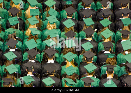 High school students in caps and gowns look forward to future after graduation. Stock Photo