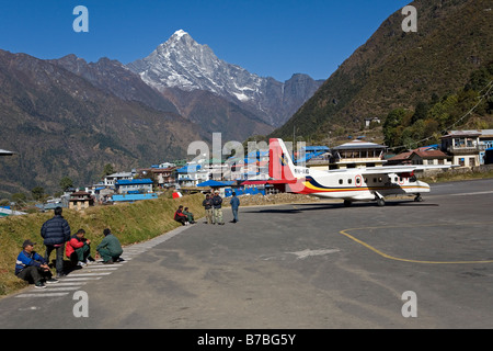 Local porters waiting for another plane arriving at Lukla airport in Nepal Stock Photo