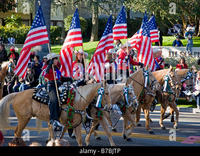 Horseback riders with American Flags in the annual New Years Day Rose Bowl Parade, Pasadena, California, USA Stock Photo