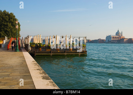 People on restaurant terrace with San Giorgio Maggiore in the background in Dorsoduro district of Venice Italy Europe Stock Photo