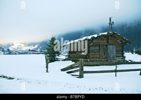 old fashioned Austrian shed in field in winter Stock Photo