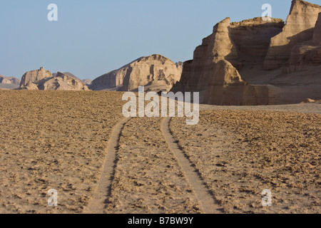 Tracks Leading into the Desert Scenery of Kaluts near Kerman Iran Stock Photo