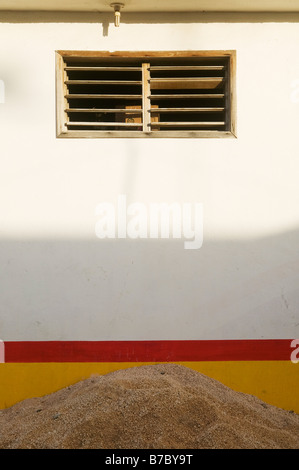 Sand Pile, White Wall, & Light Bulb Stock Photo