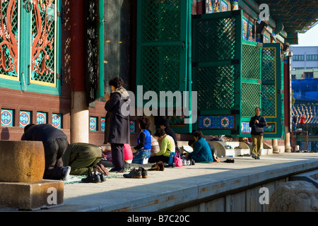 People Praying at Hall of the Great Hero or Daeung jeon at Jogyesa Buddhist Temple, Seoul, South Korea Stock Photo