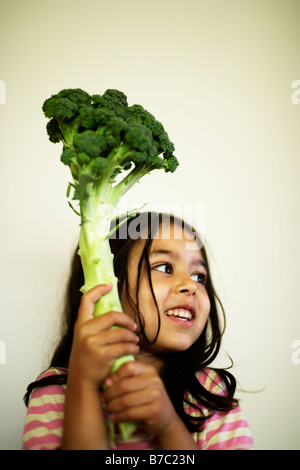 Five year old girl with Broccoli Stock Photo