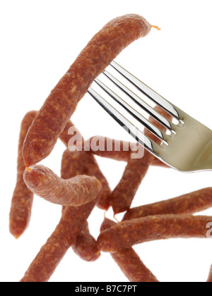 Fresh Tasty Spiced Pfiffikus Austrian Sausages On A Fork Isolated Against A White Background With No People and A Clipping Path Stock Photo