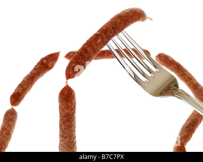 Fresh Tasty Spiced Pfiffikus Austrian Sausages On A Fork Isolated Against A White Background With No People and A Clipping Path Stock Photo