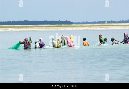 Ladies catching fish in a net Stock Photo