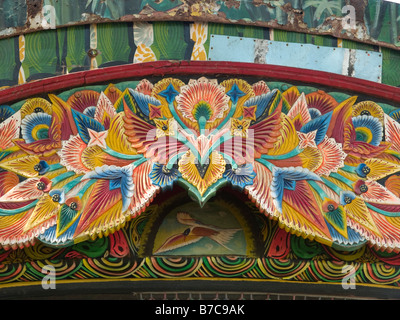 the carved and gaily-painted front-board of an owner-driver lorry in Cochin, India Stock Photo