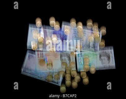 Falling blurred UK currency, banknotes and pound coins sterling to illustrate the falling pound Stock Photo