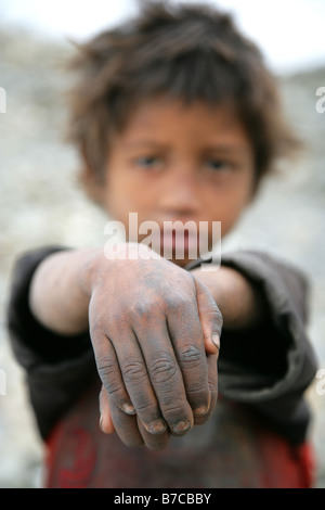 Nepalese boy with filthy hands Stock Photo