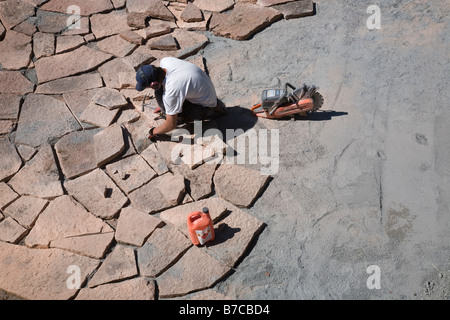 Man laying limestone slabs on a terrace Stock Photo