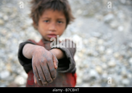 neglected Nepalese boy with filthy hands Stock Photo