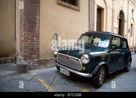 Old green Austin Mini Cooper on street in Sienna Italy Stock Photo