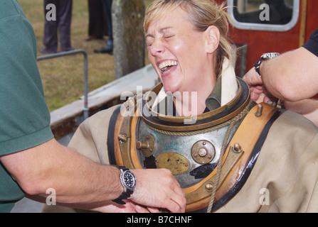 laughing female diver old antique diving kit exhibition River Rother Rye Maritime Festival East Sussex England UK Europe Stock Photo
