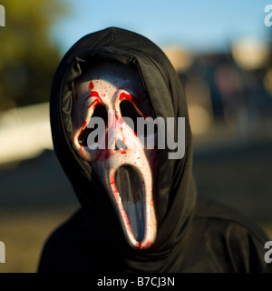 A child, Nadine Bennett, is dressed up as the scream character for halloween. Stock Photo