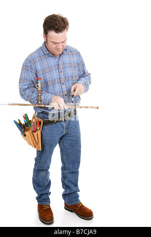 Full body view of a plumber working on copper pipe Isolated on white Stock Photo