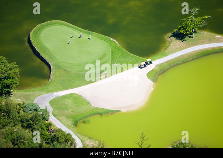 Aerial view of golf course in luxury resort in Mauritius. Four people playing golf. Stock Photo