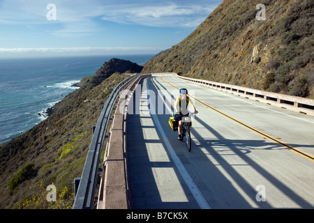 Bicyclist traveling on Highway Rt. 1 between San Simeon & Gorda, California, USA Stock Photo