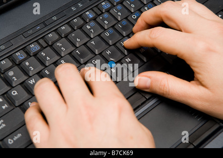 Close up of a person working on a laptop computer Stock Photo