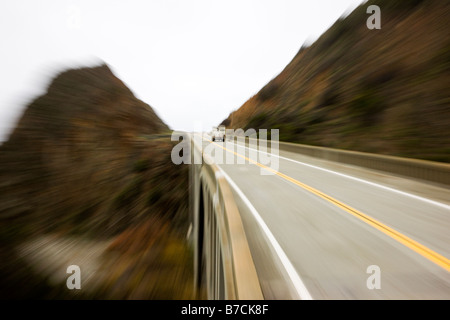 Pick up truck with a camper in the bed crosses Big Creek Bridge, Highway Rt. 1, Big Sur Coast, California, USA Stock Photo