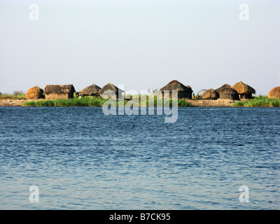 Typical straw hut village on banks of Lower Luapula River a tributary of the Congo in Democratic Republic of Congo