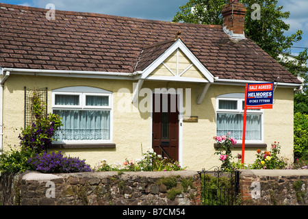 Small bungalow with sale agreed sign Devon England Stock Photo