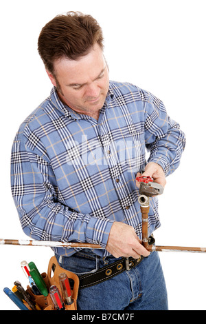 Plumber working on a copper pipe Isolated on white Stock Photo