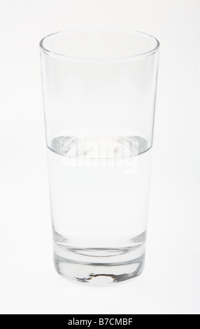 clear tall glass half empty full with water on white background Stock Photo