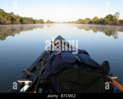 Prow of canoe canoeing in early morning on Luapula or Congo river close to Zambian town of Chembe Zambia Stock Photo