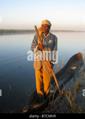 One eyed fisherman in dugout canoe on banks of Luapula tributary of Congo River Democratic Republic of Congo Stock Photo