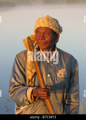 One eyed fisherman in dugout canoe on banks of Luapula tributary of Congo River Democratic Republic of Congo Stock Photo