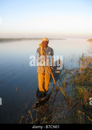 One eyed fisherman in dugout canoe on banks of Luapula tributary of Congo River Democratic Republic of Congo Stock Photo