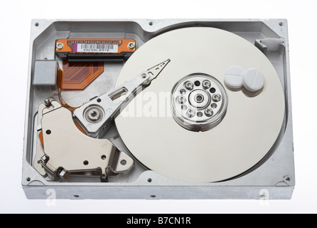 two paracetamol tablets sitting on the platter of a computer hard drive Stock Photo
