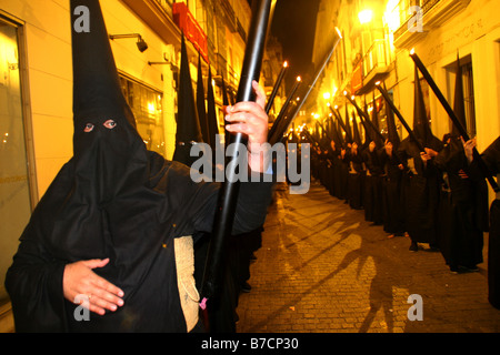 Procession of a fraternity, Cofradia, during the Holy Week, on the night with black hoods and burning candles, Spain, Andalusia Stock Photo