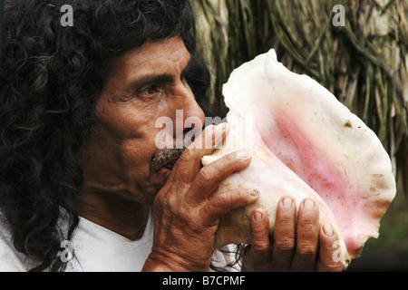 Shaman of the Lacandon Indians calls with conch the gods during ritual in Maya temple in Naha in the Lacandon jungle in Chiapas Stock Photo