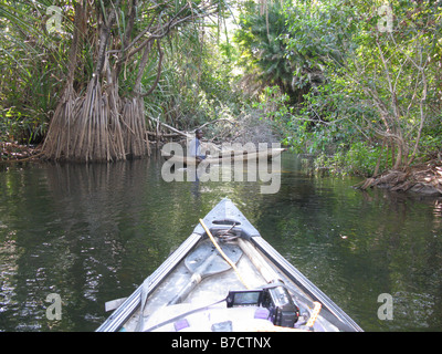 Canadian canoe prow with Bemba fisherman in dugout canoe on Luapula river close to Mambilima Falls Democratic Republic of Congo Stock Photo