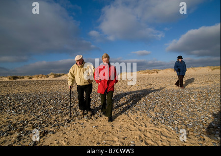 Elderly couple walking on the beach Suffolk Britain Model released  2008 Stock Photo
