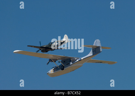 PBY-5A Catalina amphibious flying boat with Curtiss P40 Kittyhawk fighter escort Stock Photo