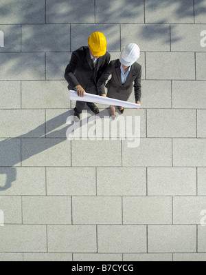 Two architects looking at a blueprint Stock Photo