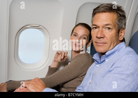 A couple sitting on a plane Stock Photo