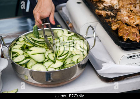 Sliced cucumbers ready to be added to a chicken satay wrap Stock Photo