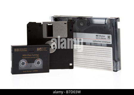 pile of old style mixed magnetic media tape cartridge dds dat tapes and floppy disc on a white background Stock Photo