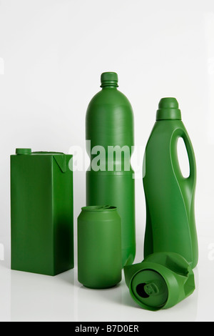 A milk carton, soda can, water bottle and laundry detergent bottle painted green Stock Photo