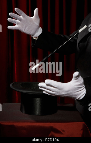 A magician's gloved hands performing a magic trick Stock Photo
