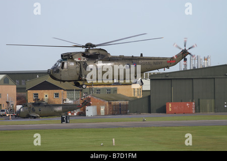 British Royal Navy Westland Sea King HC4 troop carrying helicopter taking off at RNAS Yeovilton Somerset in January 2009 Stock Photo